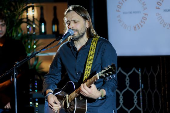 Roman Kuzmin from TECE singing and playing guitar at the get-together of the Foster Magazine event.