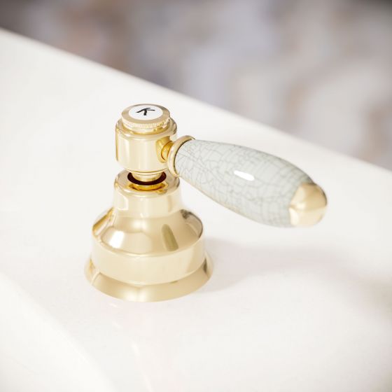 Jörger Delphi washbasin fittings in finish sunshine with  lever handles of white porcelain, covered in a fine network of craquelure